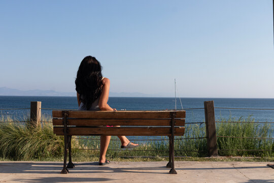 young woman sitting on a bench