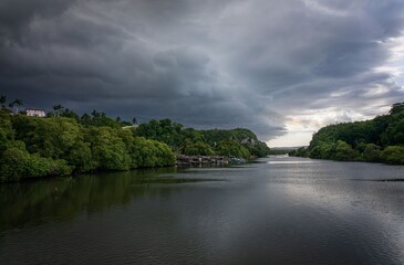 Obraz premium River landscape with dramatic clouds.