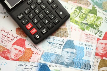 Pakistan rupees banknotes and calculator. The current Pakistan money bills with calculator