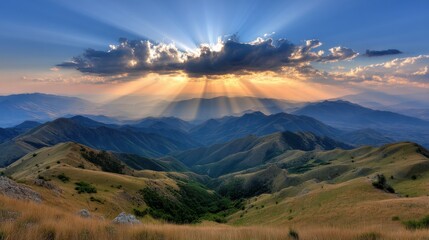Obraz premium Sun rays break through clouds over rolling green mountains at sunrise or sunset