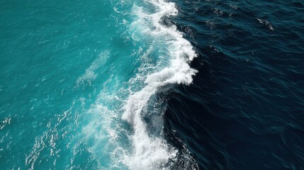 Vivid ocean waves crashing with foam and spray in contrasting shades of blue and turquoise