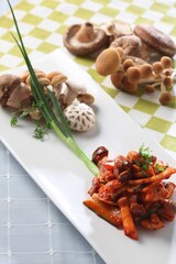 Assorted mushroom salad with pine mushrooms, white button mushrooms, and velvet pioppini served with chili sauce. Created by Korean master chef Hanshunseop.