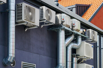 Modern HVAC Air Conditioning and Ventilation System Units Mounted on Building Exterior Wall