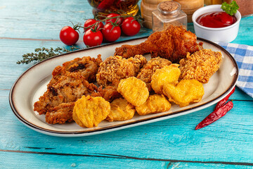 Golden crispy fried chicken mix - wings, drumsticks, nuggets and strips