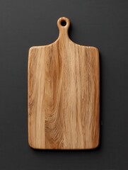 Fototapeta premium rectangular wooden cutting board with handle on dark background