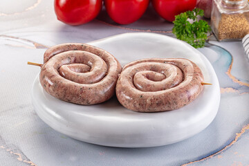 Raw meat pork and beef swirl sausages