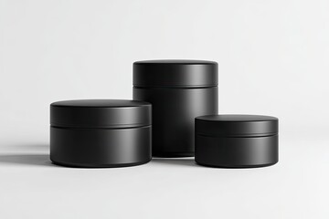 Three black cosmetic jars of varying sizes, against a white background