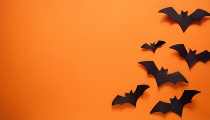 Fototapeta premium Halloween Orange Background with Flying Bats and Minimal Copy Space for Festive Text