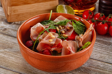 Salad with jamon, strawberry and arugula