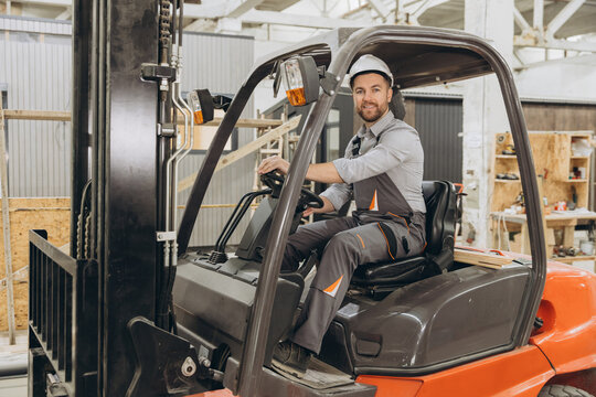 Factory worker driving forklift in modular building industry