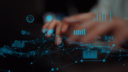 Close-up view of hands typing on a keyboard with digital data visualization elements, showcasing graphs and charts for financial analysis and technological insights. Xenic