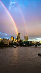 Double rainbow over cityscape