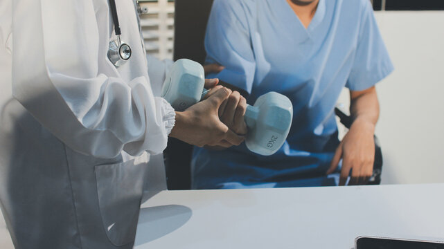 Person using hand weight with support of nurse - Powered by Adobe