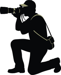 Silhouette of photographer kneeling and taking a picture with camera