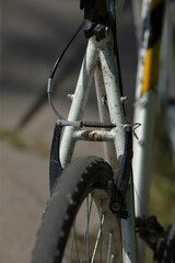 Here is a detailed closeup view of a bicycle showcasing its distinct black tire, highlighting the various components that make it unique