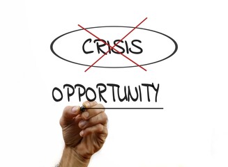 Hand Writing 'Opportunity' and 'Crisis' Representing Positive Change and Growth