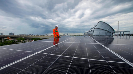 Technician inspects solar panels on a rooftop under cloudy skies in an urban area