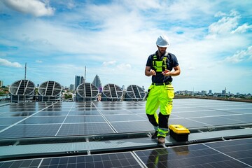 Solar technician monitors solar panels on rooftop in urban setting during bright sunny day