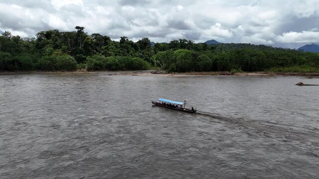 Aerial view of a longtail boat sailing down river in the jungle. Madidi Bolivia