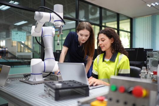 Collaboration between two students using robotic technology in a modern lab setting
