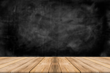 Rough wooden table with black wall background