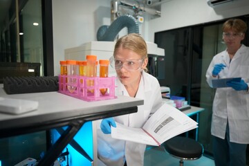 Laboratory researchers examine samples under artificial lighting in a modern facility