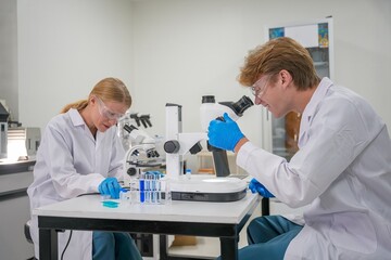 Scientists conduct research in a laboratory using microscopes and samples