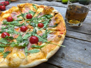 Home made pizza with cherry tomatoes and mozzarella cheese.  High-quality photo