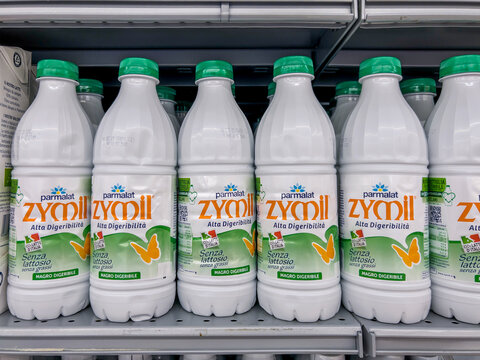 Italy - August 5, 2025: Parmalat Zymil highly digestible lactose-free milk in plastic bottles displayed on shelves for sale in an Italian supermarket.
