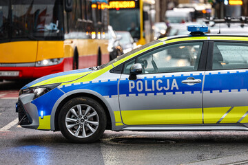 Żółto srebrny radiowóz służbowy policji w mieście © FotoDax