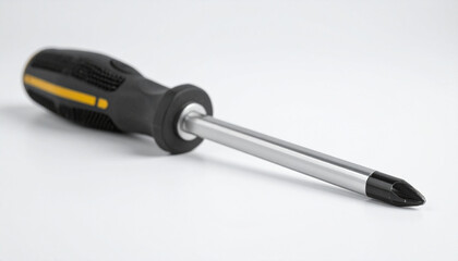 Screwdriver with metallic tip on clean white backdrop. Working tool.