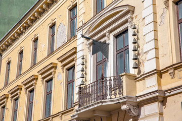 Historic baroque building facade with ornate balcony details. Nagykanizsa, Hungary.