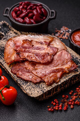 Cooked fried crispy bacon as an ingredient of a delicious English breakfast. Pieces of fried bacon