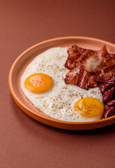 Fried egg, bacon and beans, a classic British breakfast with tomatoes. Egg, bacon and beans