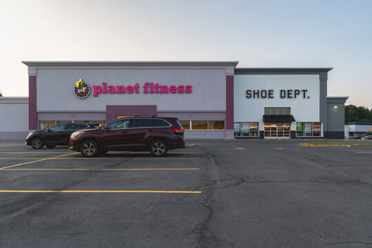 New Hartford, NY - Aug 2, 2025: Close-up view of Crossroad Plaza parking lot in foreground, and Planet Fitness and Shoe Dept. in background