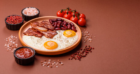 Fried egg, bacon and beans, a classic British breakfast with tomatoes. Egg, bacon and beans