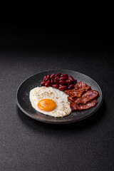 Fried egg, bacon and beans, a classic British breakfast with tomatoes. Egg, bacon and beans