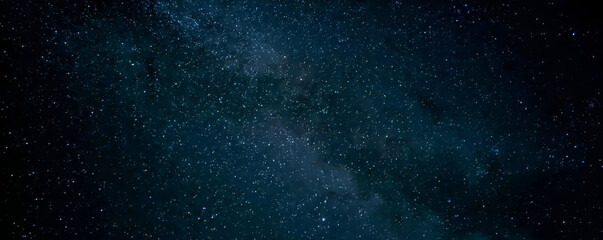 Galaxy exploration through outer space towards glowing milky way galaxy. High quality, beautiful night sky time lapse with Milky Way galaxy on dark sky. Starry night background.