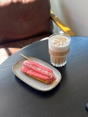 Latte in a glass and a pink croissant, latte art, food photos 
