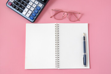 Top view of notebook and pen on background.