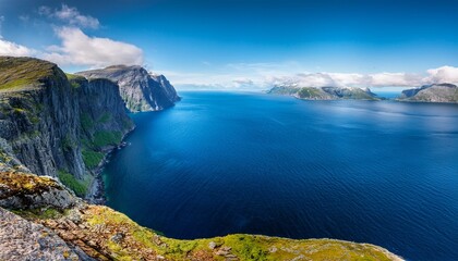 a majestic atlantic ocean fjord unfolds framed by towering cliffs and lush greenery the deep blue waters contrast with the vibrant hues of the surrounding landscape creating a breathtaking panorama