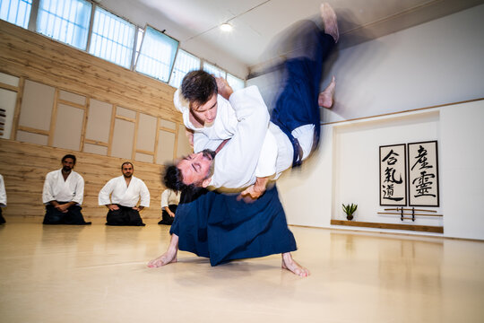 Martial Artists Practice Throwing Techniques During Training Session in Dojo