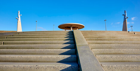 Concrete steps and modern sculptures bask in November sun along Cleveleys seafront, famously transformed into the beach planet Niamos in Andor, Episode 7.