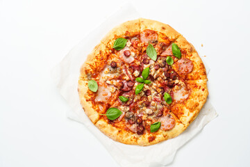 Delicious meat pizza with ham, salami and sausages.
