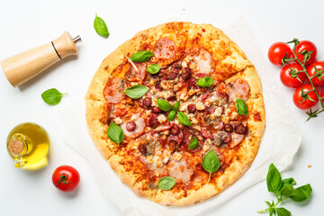 Delicious meat pizza with ham, salami and sausages.