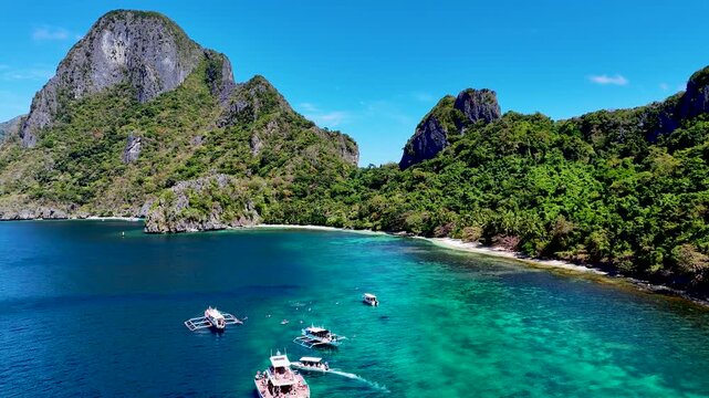 Island hopping at El Nido, Palawan, Philippines archipelago. Tour A, B, C, D with traditional Filipino boats. Aerial 4K drone video footage