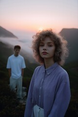 Fototapeta premium Young caucasian female and male in scenic mountain sunset landscape