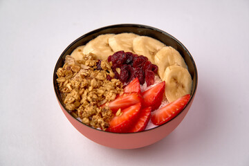 Colorful and Nutritious Breakfast Bowl Filled with Yogurt, Fresh Strawberries, Bananas, Crunchy Granola, and Dried Cranberries for a Healthy Start to the Day