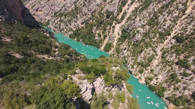 Diving down rockie mountains to aqua blue river, FPV, Gorges du Verdon, France, 4K