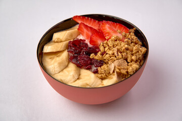 A Colorful Bowl of Yogurt with Fresh Strawberries, Sliced Bananas, Crunchy Granola, and a Drizzle of Tart Cranberry Sauce for a Healthy Snack